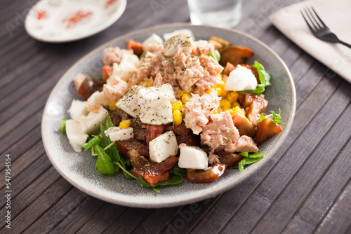 Plate of salad with tuna, corn, tomatoes and arugula
