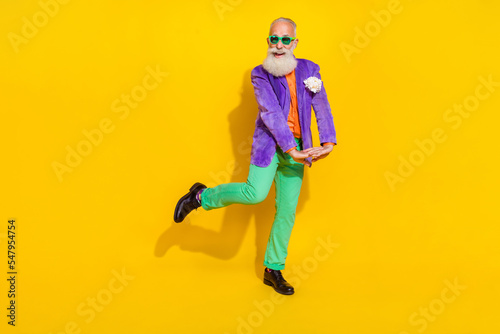 Full size portrait of positive cheerful granddad have good mood chilling isolated on yellow color background