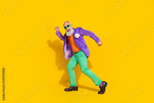 Full length photo of nice granddad celebrate weekend holiday dancing dressed stylish colorful outfit isolated on yellow color background