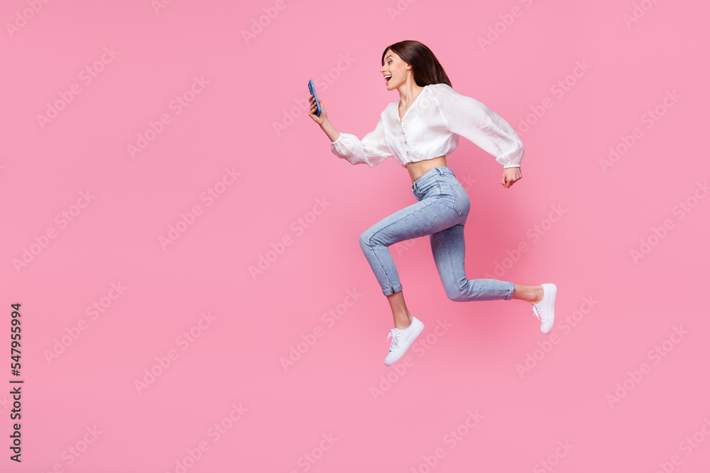Full length photo of positive lady denim stylish outfit hurry up discount device gadget shop empty space isolated pink color background