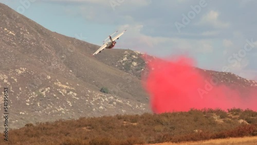 Airplane drops red fire retardant over Fairview wildfire in California