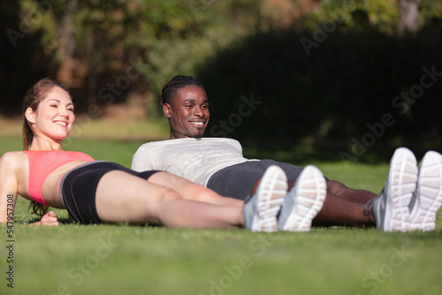 fitness couple stretching outdoors in park