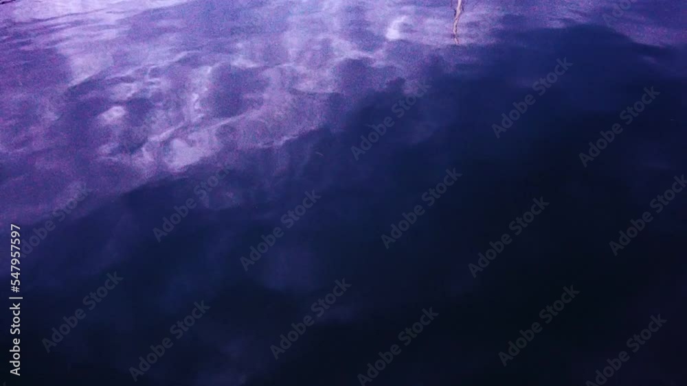 Water background. Ripples on the water with the reflection of the sky ...