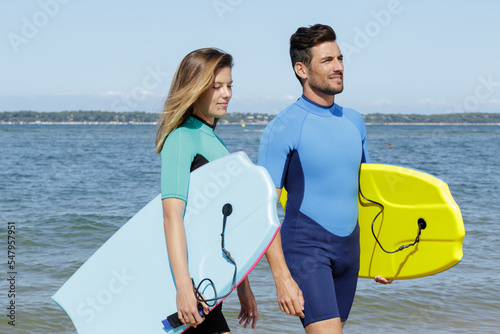 surfers on beach having fun in summer photo