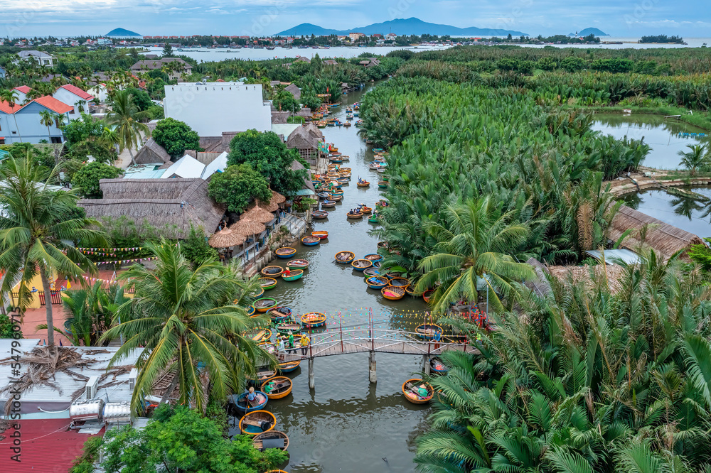 AERIAL VIEW, TOURISTS FROM THAILAND, KOREA, AMERICA AND JAPAN ARE RELAX AND EXPERIENCING A BASKET BOAT TOUR AT THE COCONUT WATER ( MANGROVE PALM ) FOREST IN CAM THANH VILLAGE, HOI AN,QUANG NAM,VIETNAM