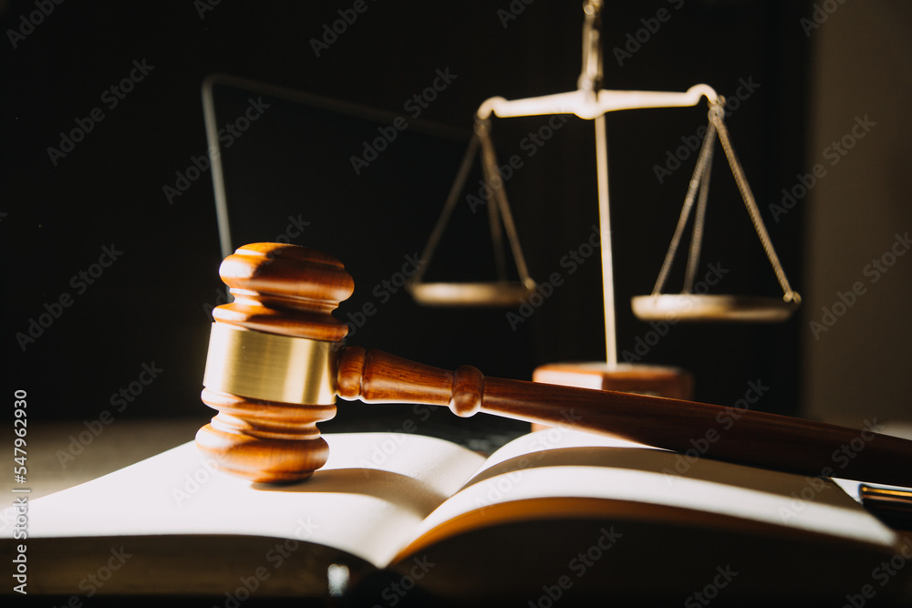 law books and scales of justice on desk in library of law firm. jurisprudence legal education concept. law books and scales of justice on desk in library of law firm. jurisprudence legal education concept.