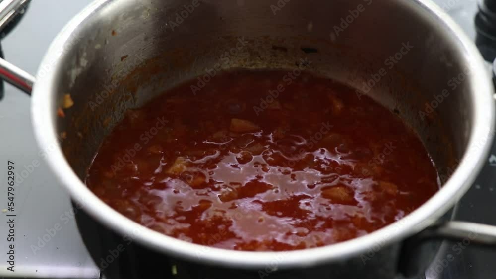In the kitchen, add lentils to the onion and tomato paste sauce fried with oil in a metal pot and mix. In the kitchen, add lentils to the onion and tomato paste sauce fried with oil in a metal pot and mix.