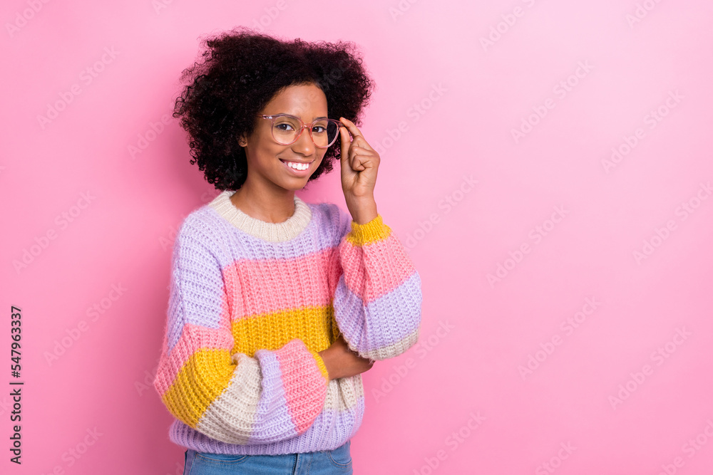 Photo of teenager schoolgirl wear knitted sweater touch spectacles positive smiling empty space shopping offer isolated on pink color background
