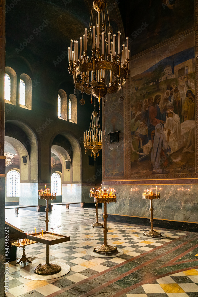 interior view of the main hall of the Alexander Nevsky Cathedral with votive candles and images