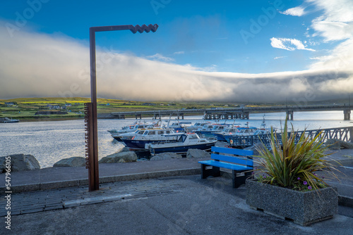 Landscape of Pormagee harbour and Valentia Island surrounded by clouds.