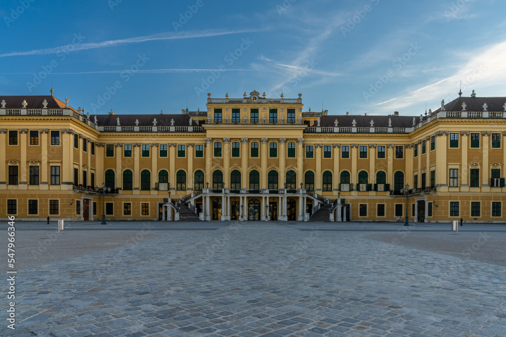 view of the front of the historic Schoenbrunn Palace in Vienna in warm evening light