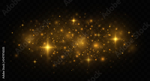 Golden shiny light effect. The dust sparks and golden stars shine with special light on transparent background.