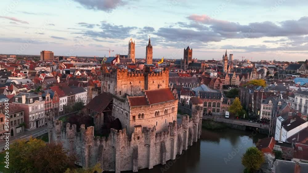 Aerial view of famous places Castle of the Counts next to river Lys. Beautiful architecture and landmarks of the medieval city on a sunset. Ghent, Belgium