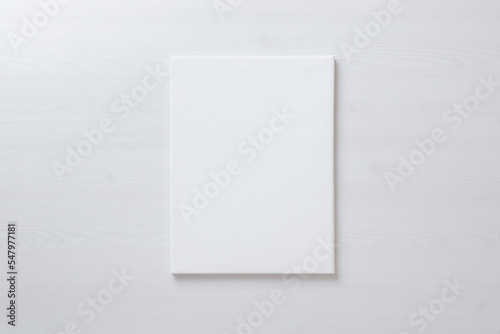 Vertical blank art canvas frame mockup for arts painting and photo presentation mockup. Laid on the floor photo
