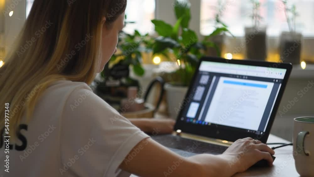 Girl sit down at home office desk table to work remotely, Female business woman scroll web page on using laptop notebook typing keyboard working online. technology distant concept, close up, in winter