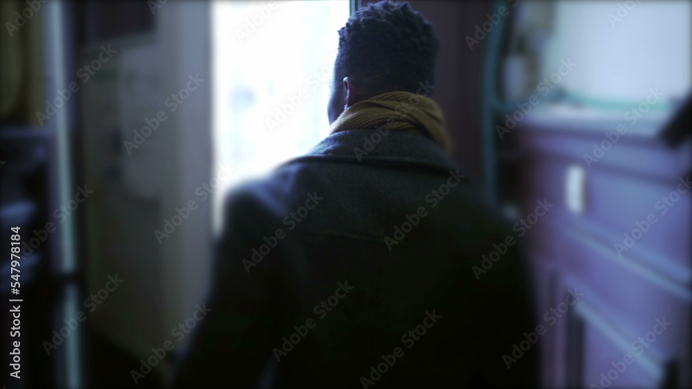 Man leaves home, opens front door, closes the door, and steps outside