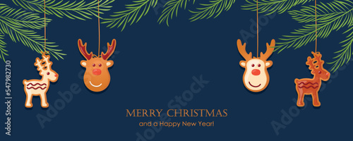 christmas card with hanging gingerbread cookies decoration and fir branches