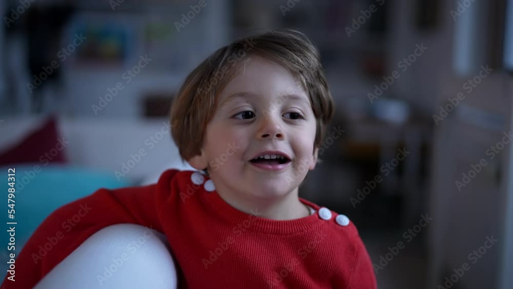 Portrait of a happy small boy closeup face standing indoors at home living room. 2 year old child wearing red sweater Portrait of a happy small boy closeup face standing indoors at home living room. 2 year old child wearing red sweater