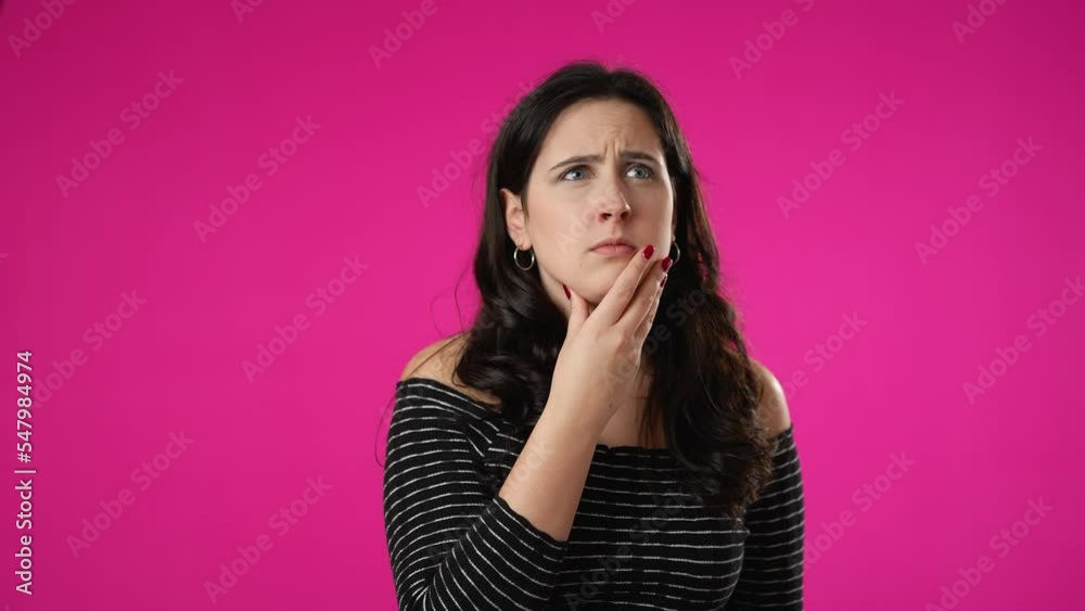 Portrait of thinking, smart puzzled pensive young hipster woman 20s looks around thinks comes up with ideas raised finger thumbs up isolated on pink background studio portrait Portrait of thinking, smart puzzled pensive young hipster woman 20s looks around thinks comes up with ideas raised finger thumbs up isolated on pink background studio portrait