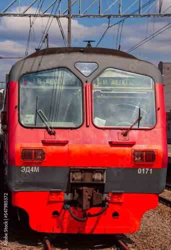 Head wagon of the ED4M electric train on the railway tracks on the station platform.