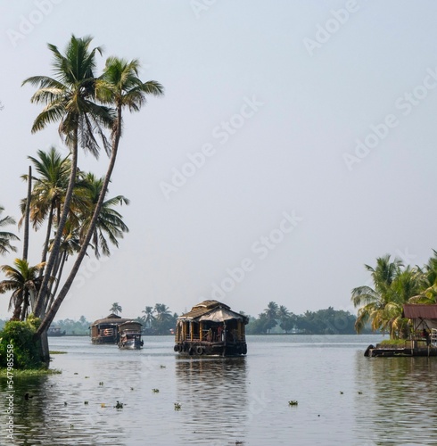 Low-angle of Indian bayous houseboats backwater tour karela against gloomy sky