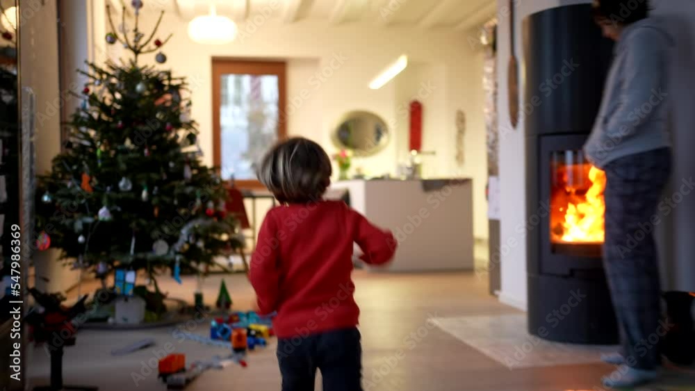 One excited happy child running in modern living room home. Back of small kid runner in house interior. Handheld footage One excited happy child running in modern living room home. Back of small kid runner in house interior. Handheld footage