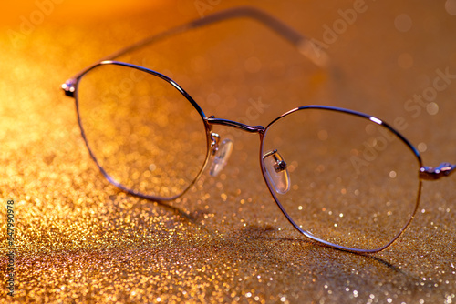 Gold-rimmed spectacles on lights background,Gold Glitter Sparkle Confetti Background
