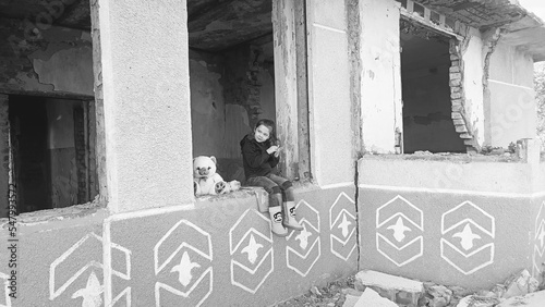 Children against war. Consequences of the war in Ukraine. The child sits in a destroyed house. Russian aggression against Ukraine. Destruction of Ukrainian infrastructure. War in Ukraine.