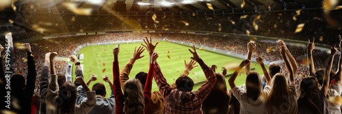 Victory. Back view of football soccer fans cheering their team with colorful scarfs at crowded stadium at evening time. Concept of sport, cup, world, team, event, competition © master1305