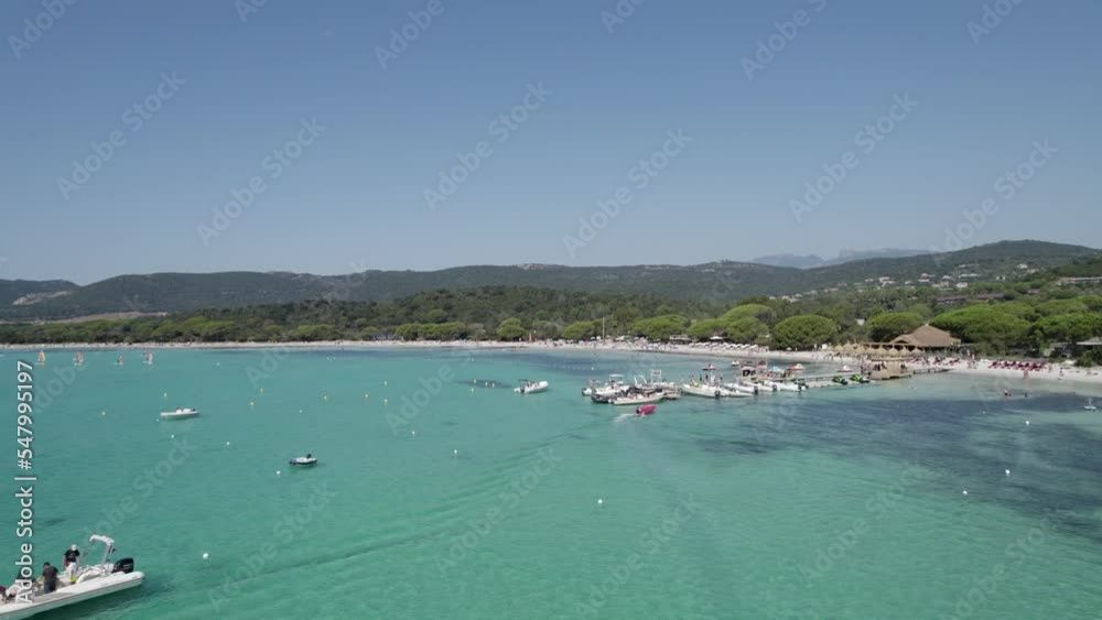 Corsica island Santa Giulia Beach part of France in Mediterranean Sea pier and assorted boats and watercraft, Aerial dolly left shot Corsica island Santa Giulia Beach part of France in Mediterranean Sea pier and assorted boats and watercraft, Aerial dolly left shot