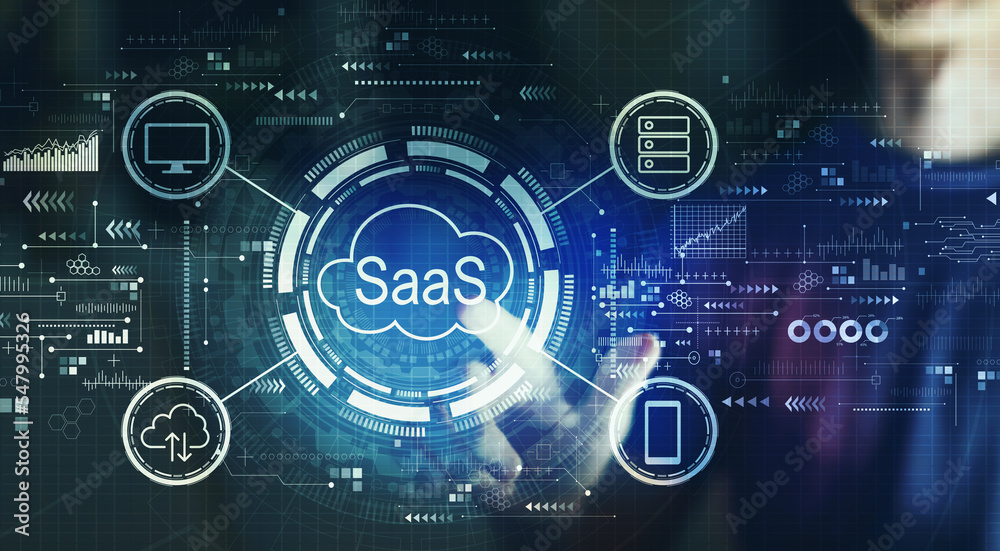 SaaS - software as a service concept with young man touching a digital screen at night SaaS - software as a service concept with young man touching a digital screen at night