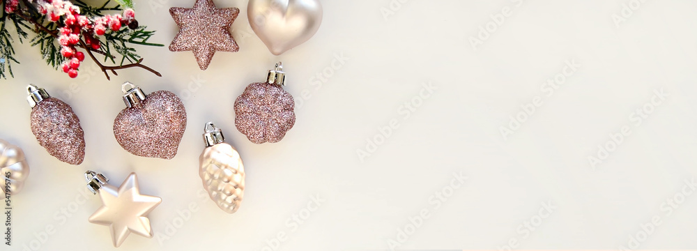 Christmas toys - golden balls and a gift box on the beach, blurred sea in the background. New Year or Christmas card, invitation with copy space for text