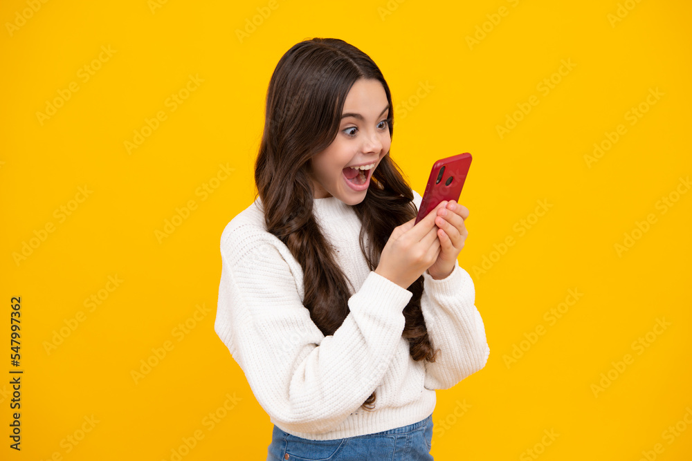 Mobile online shopping. Cute teen child girl paying with phone, texting and chatting on smartphone. Excited teenager girl. Mobile online shopping. Cute teen child girl paying with phone, texting and chatting on smartphone. Excited teenager girl.