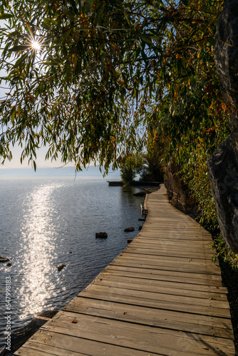 boardwalk leading along the shores of the clear blue waters of Lkae Ohrid photo
