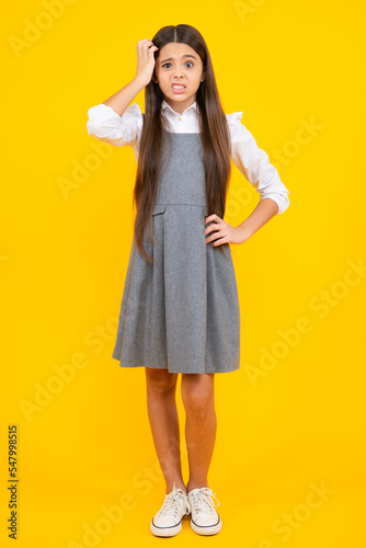 Elegant fashion teenager child girl posing in studio. Trends kids clothes. Angry teenager girl, upset and unhappy negative emotion.