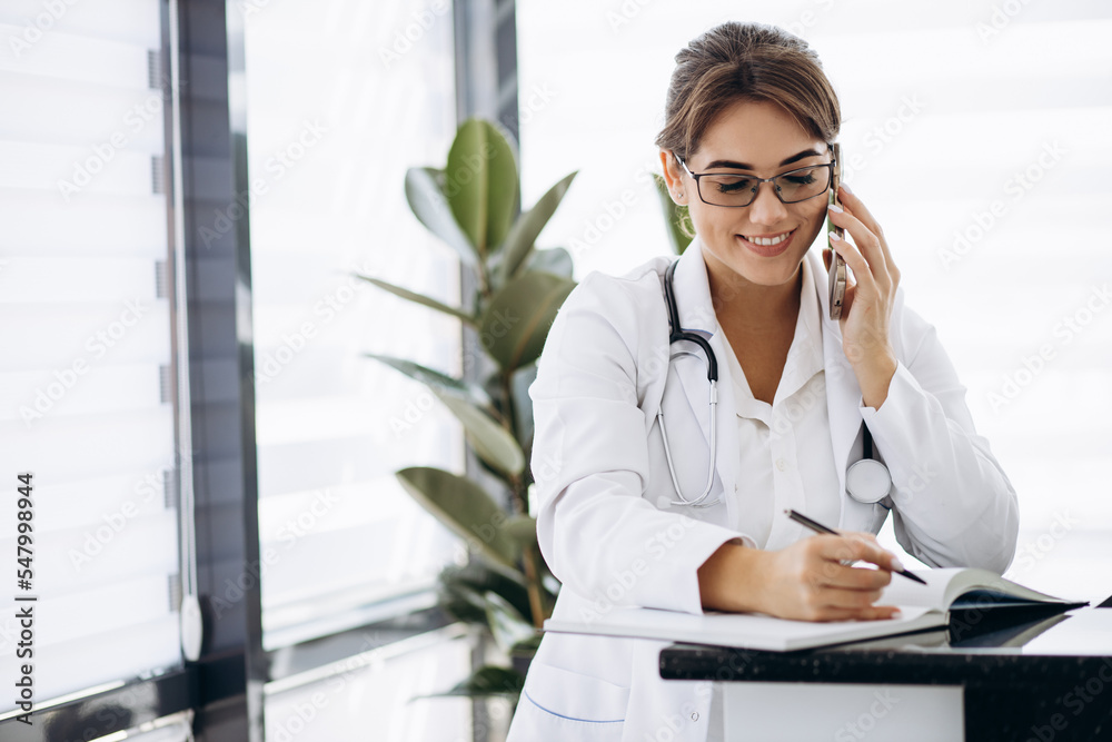 Woman doctor writing a prescription in hospital Woman doctor writing a prescription in hospital