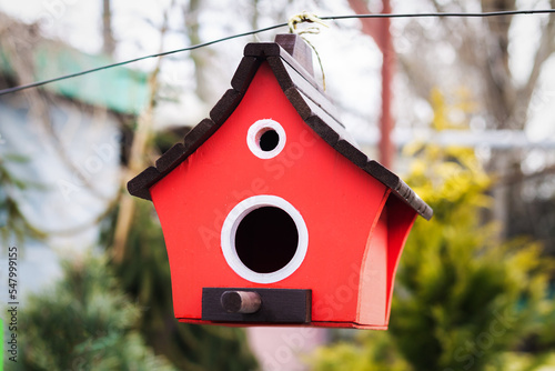 Red wooden nesting box or birdhouse hanging © Дмитрий Сидор