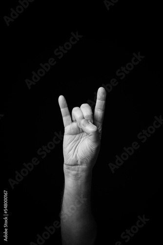 Hand demonstrating the French sign language letter 'H' with copy space