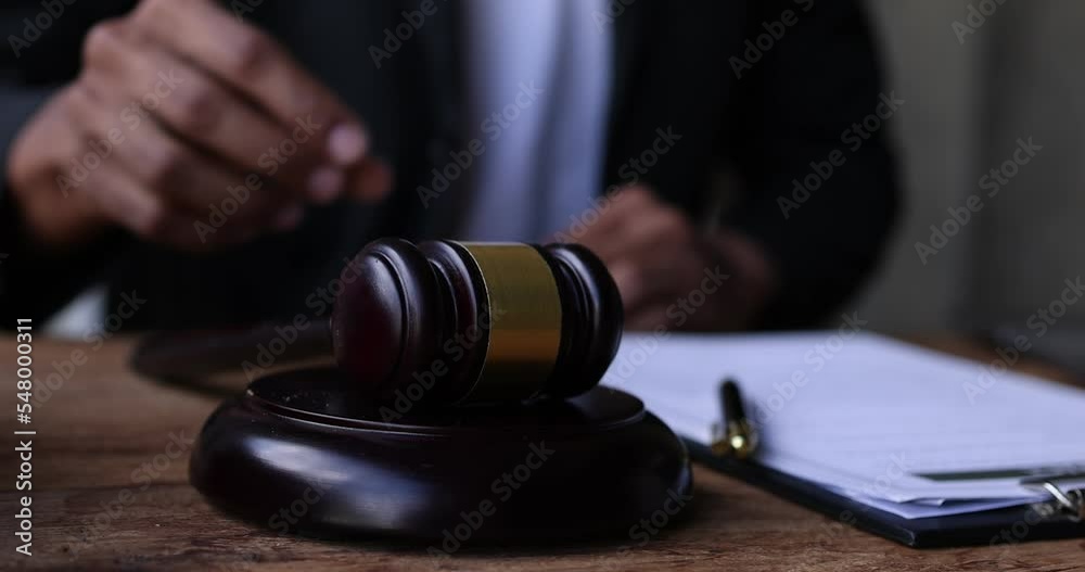 Slow motion video footage of judge giving verdict by hitting mallet at desk, justice and law judge gavel and soundboard Law concept.