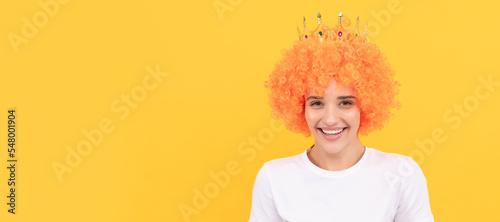 Obraz na plátně happy freaky selfish woman in curly clown wig and queen crown for party, happiness