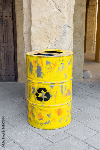 Yellow metal barrel with recycling symbol. Container with sign. waste. Disposal, utilization problem. Environmental harm © Anton