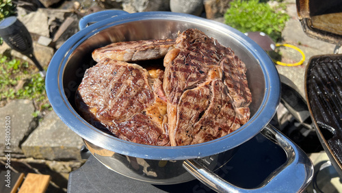 many steaks in a pot to keep them warm. High-quality photo
