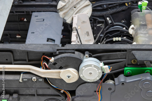 Close-up of maintenance and repair of the drive mechanism of the cash acceptor of the ATM
