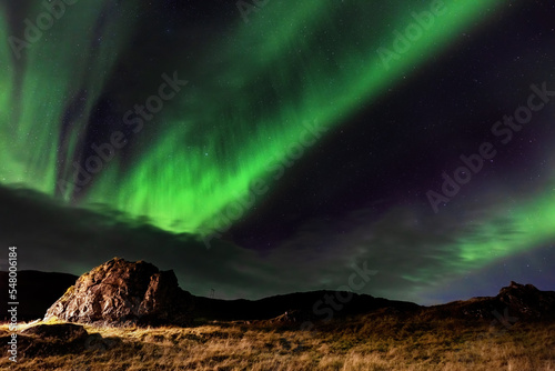 Northern lights, Aurora Borealis in the night sky, Iceland. These colourful curtains of dancing lights can illuminate the night sky in shades of green, blue and magenta