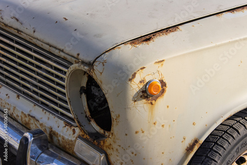 Close-up of an old rusty semi-disassembled vintage car from the USSR abandoned on the street photo