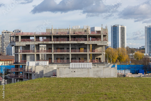Abandoned construction of a large concrete building. Stopped construction of an office building due to lack of funding