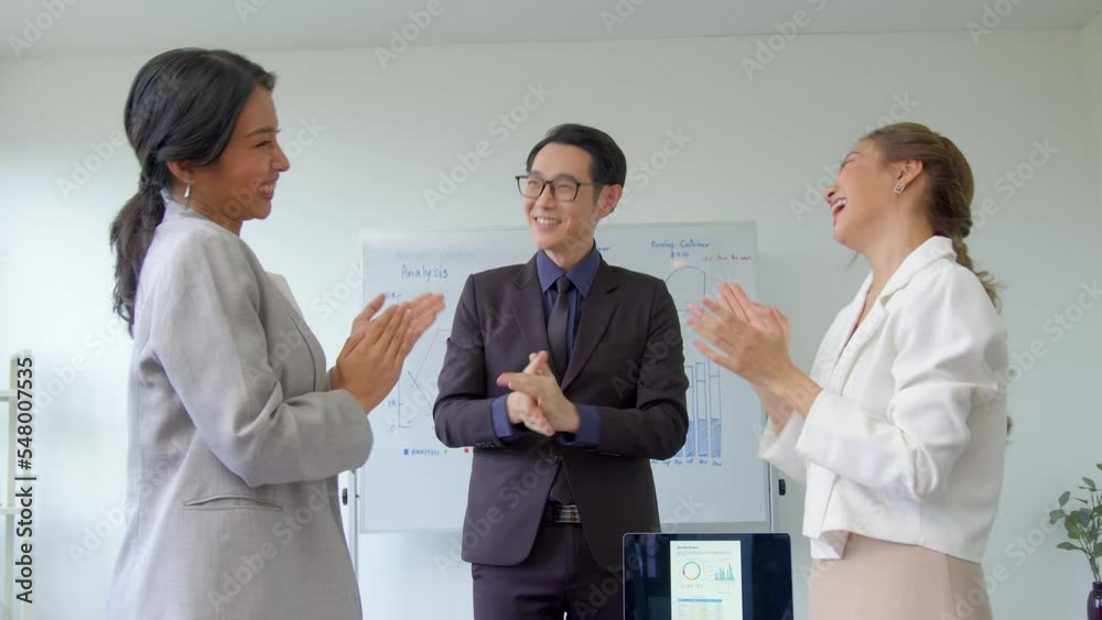 Successful business team is clapping their hands. Asian businesspeople discussion during meeting about successful of company. Successful business team is clapping their hands. Asian businesspeople discussion during meeting about successful of company.