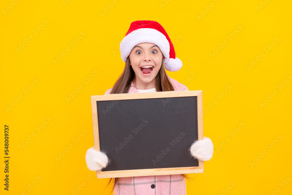 back to school. happy new year. merry christmas. amazed kid in santa claus hat with blackboard back to school. happy new year. merry christmas. amazed kid in santa claus hat with blackboard