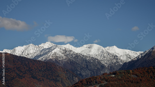 Mountains with snow-capped peaks. Beautiful panorama. Clouds over the mountains. © MadCat13Shoombrat