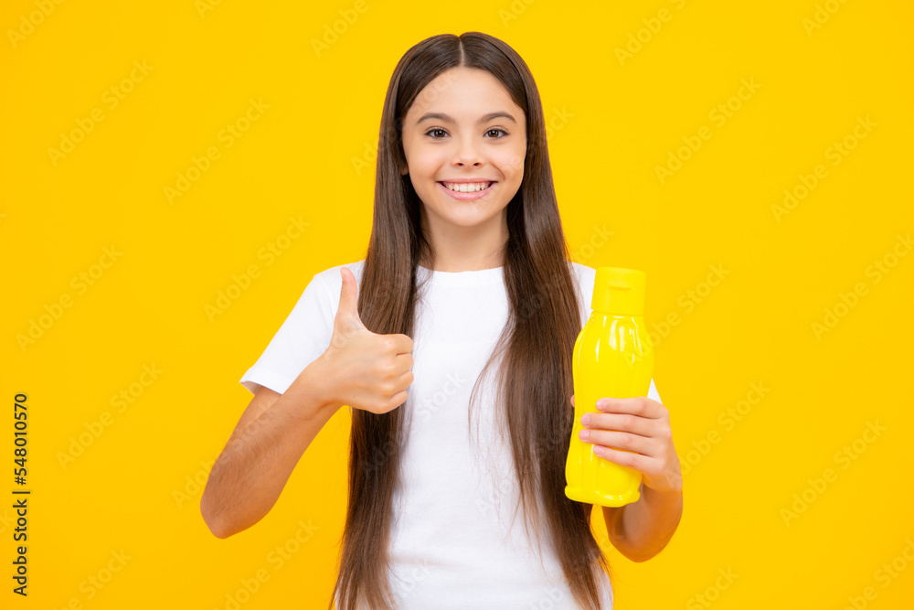 Teenager child girl with water from plastic bottle on isolated background, copy space. Kid girl care body hydration. Active leisure and water balance. Happy teenager portrait. Smiling girl. Teenager child girl with water from plastic bottle on isolated background, copy space. Kid girl care body hydration. Active leisure and water balance. Happy teenager portrait. Smiling girl.